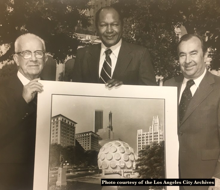 Buckminster Fuller, Mayor Tom Bradley and A.C. Martin hold the architectural rendering of the Fly's Eye Dome during a press announcement.
